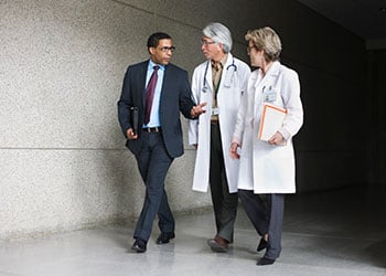 Group of 3 Healthcare Professionals Walking